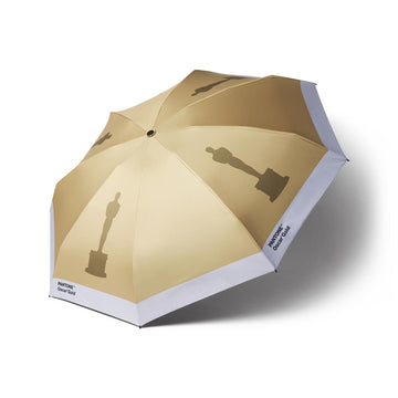Gold Oscar Statuette print logo on open umbrella